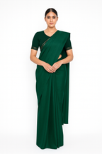 Woman wearing a green saree with a white background